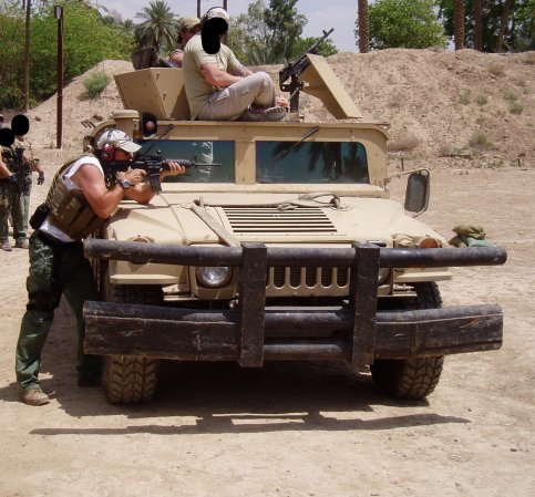 Lerette aims a firearm over a humvee