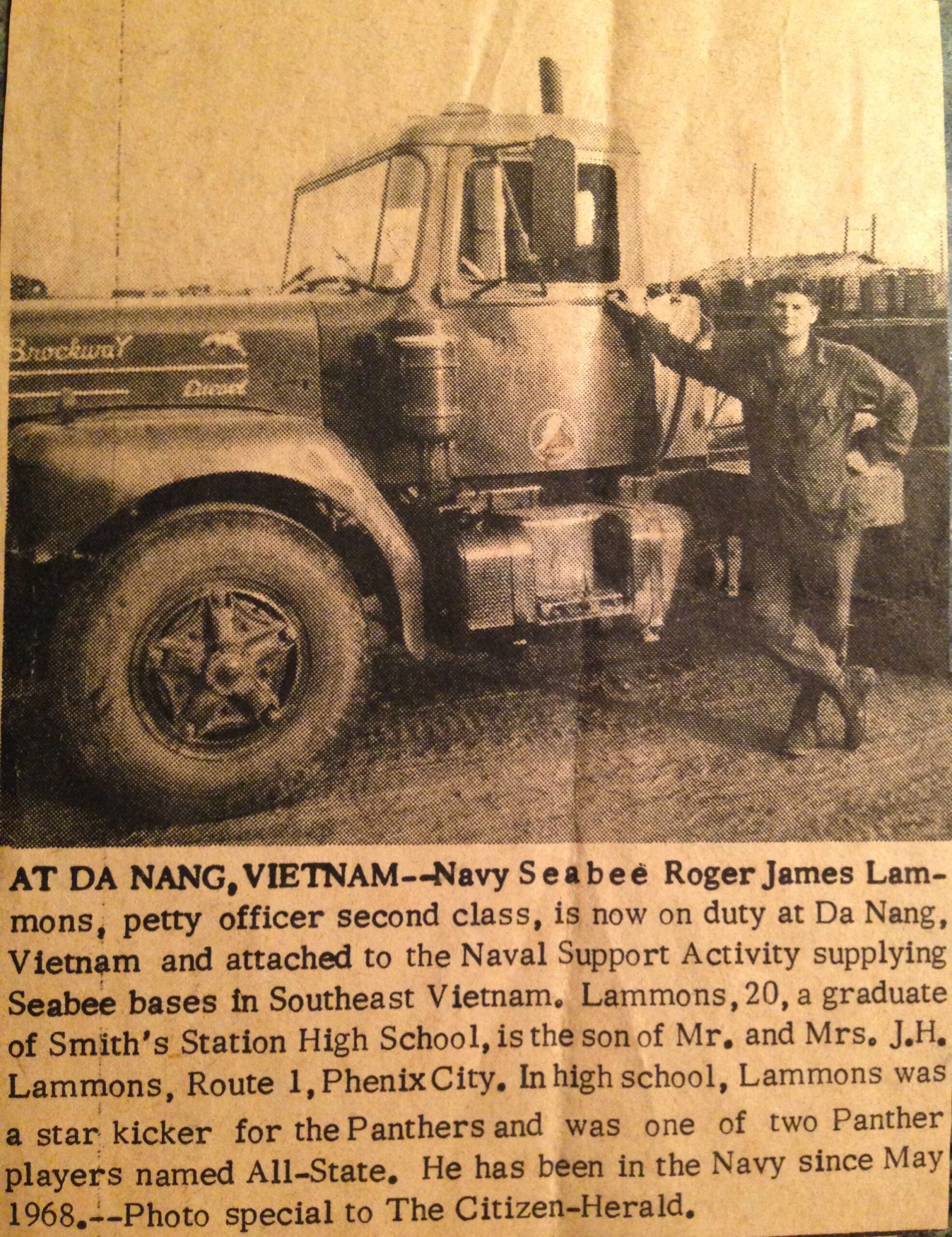 Lammons poses by a humvee