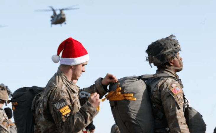 a paratrooper loads presents in a jumper's bag