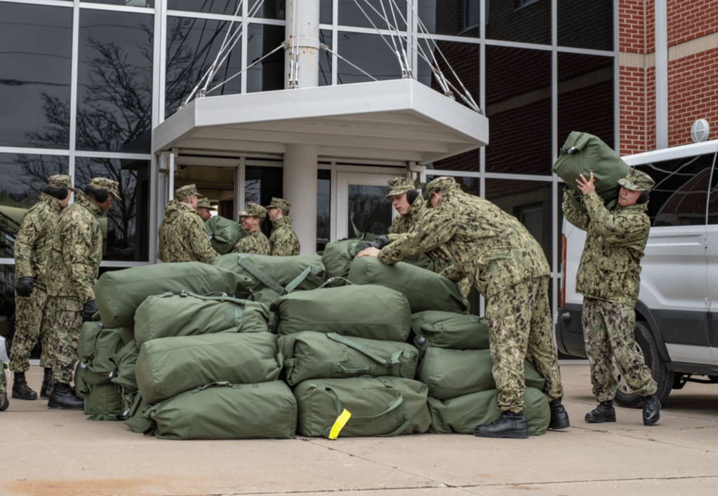 sailors stowing their stack of seabags