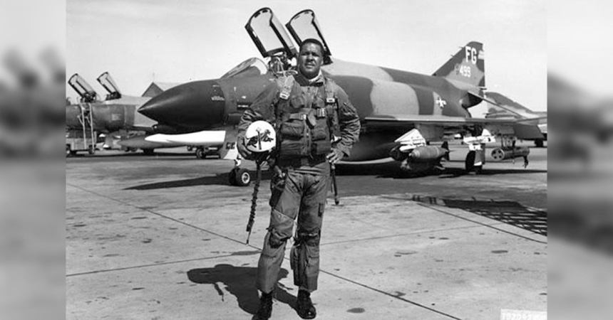 First black general Benjamin O Davis standing in front of his aircraft.