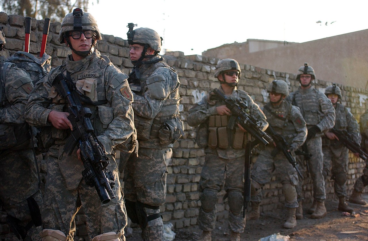 Soldiers line up against a wall in Iraq on parole.