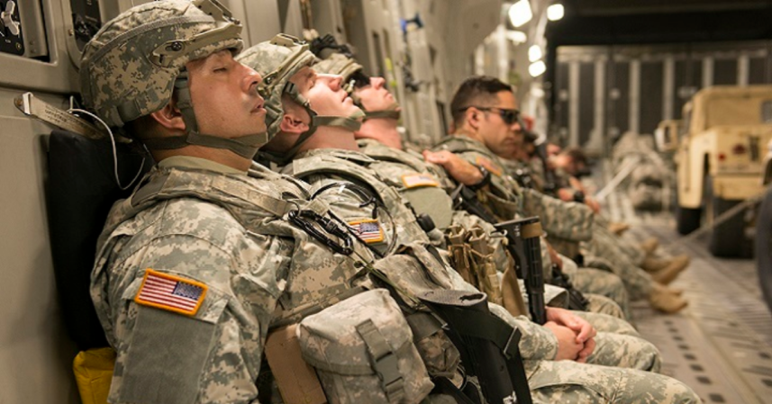 Troops sleeping on an aircraft.