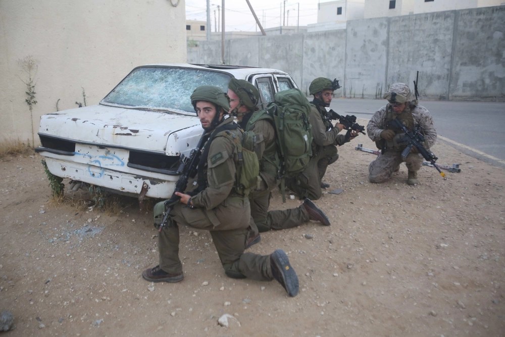 IDF soldiers and American Marines conduct joint training with M4 carbines.