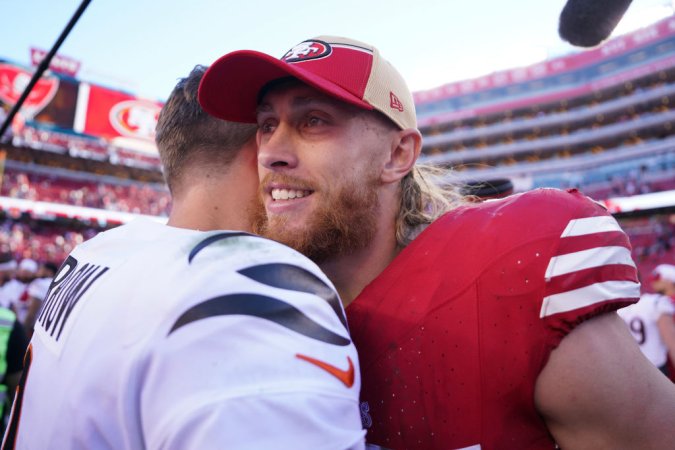 Joe Burrow of the Cincinnati Bengals embraces George Kittle.