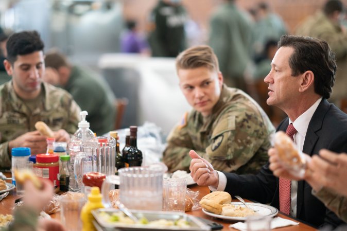 Wayne Peacock visits with service members.