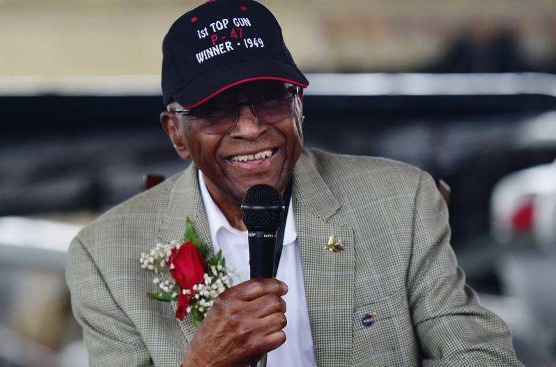 James Harvey holding a microphone and smiling.