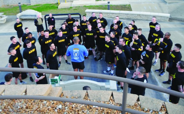 a leader addresses his soldiers in a semi-circle during Army PT