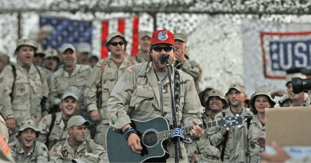 Toby Keith performs the guitar and singing in front of troops