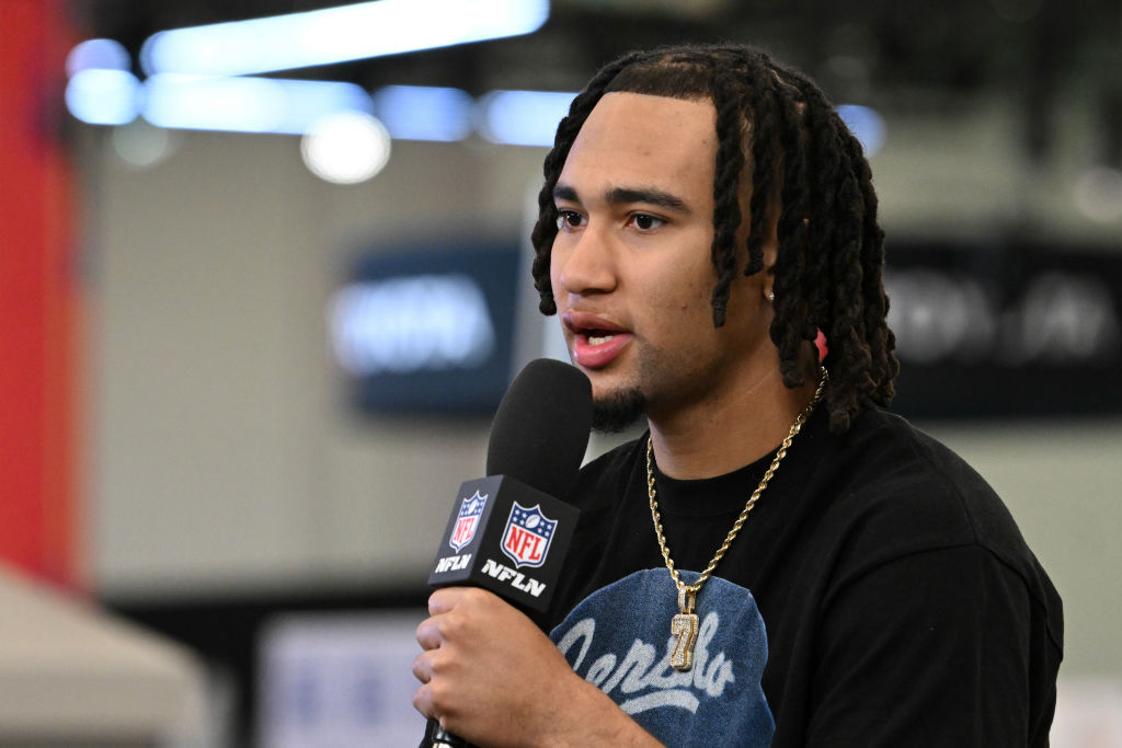 CJ Stroud holds a microphone and is speaking at the Media Row event at the Super Bowl