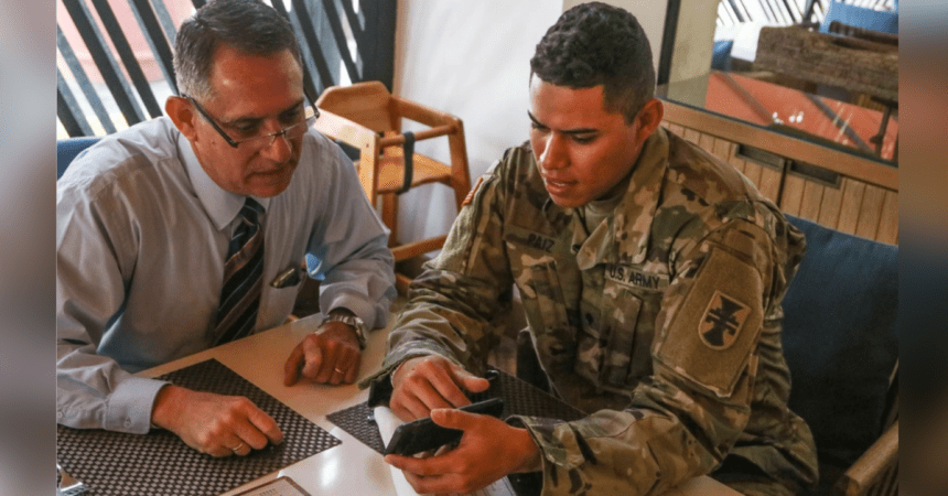 soldier looks at cell phone with his dad