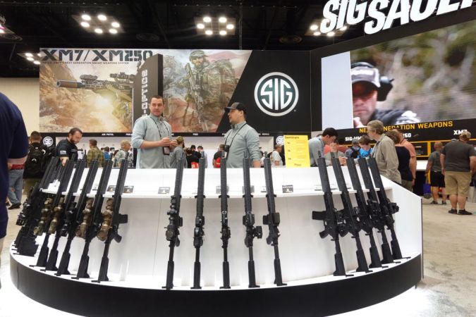 INDIANAPOLIS, INDIANA - APRIL 15: Firearms are displayed at the Sig Sauer booth at the National Rifle Association's Annual Meetings & Exhibits at the Indiana Convention Center on April 15, 2023 in Indianapolis, Indiana. The convention, which is expected to draw around 70,000 guests, opened yesterday and runs through Sunday. (Photo by Scott Olson/Getty Images)