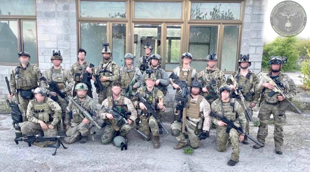 Soldiers in Ukraine pose with weapons