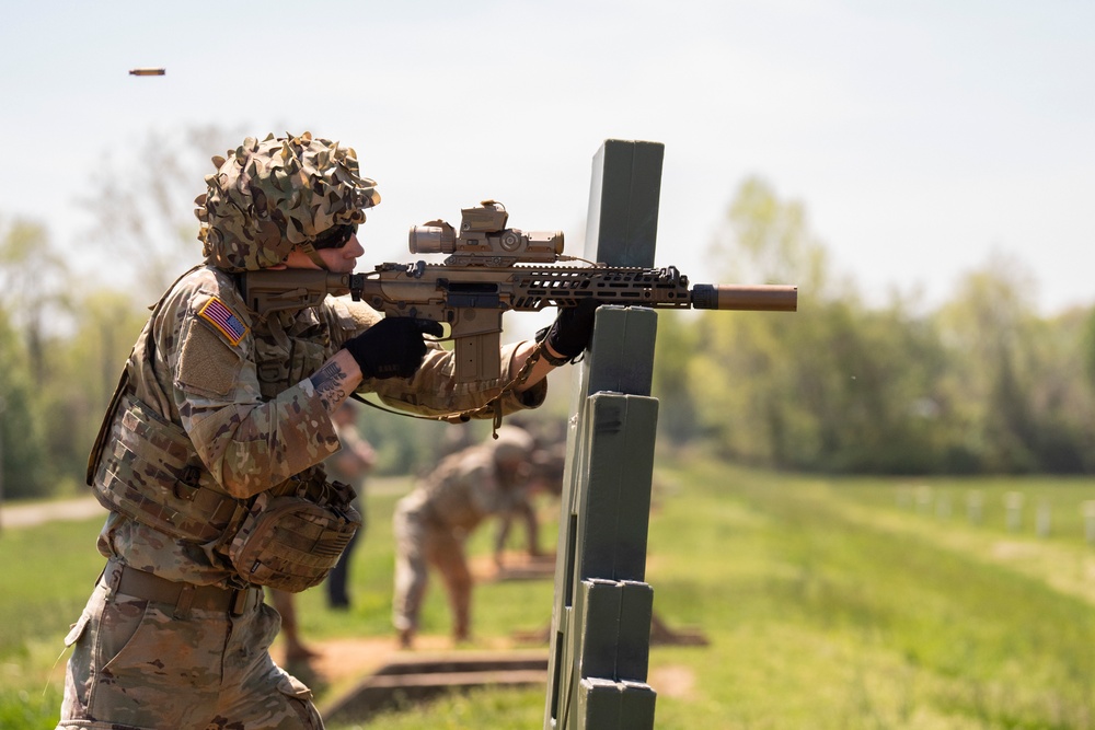 Soldier fires a machine gun