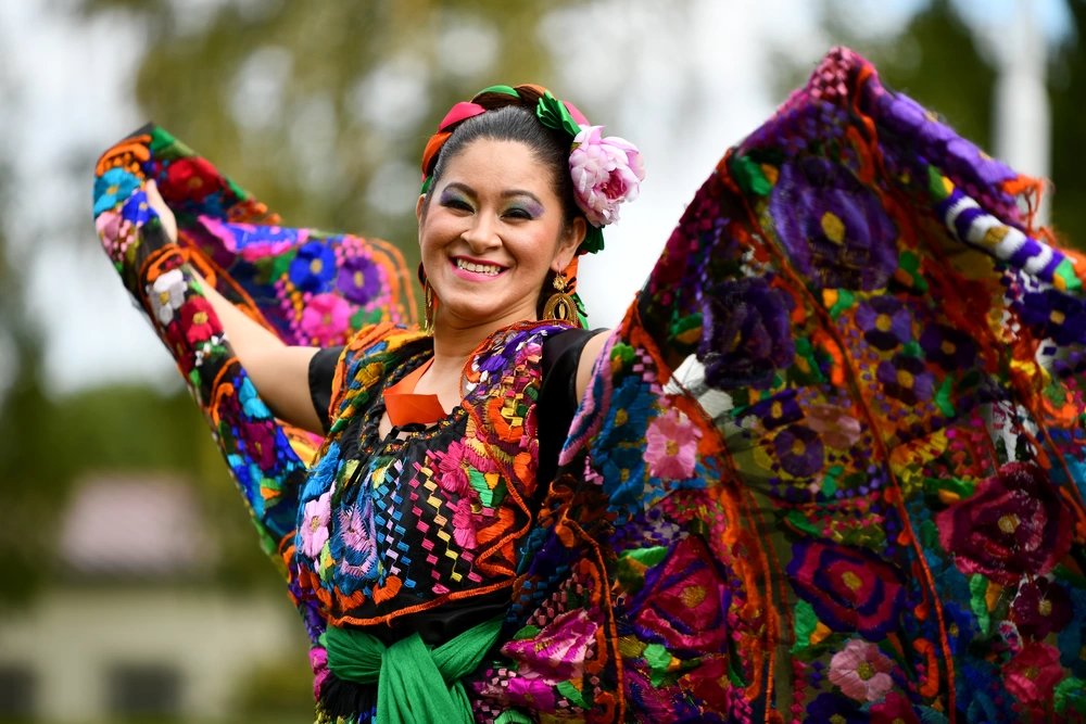 A dancer in traditional Mexican clothing performs 