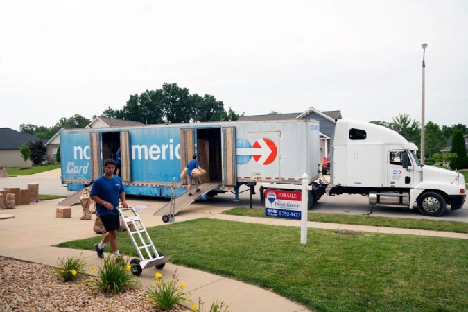 Movers pack a military members property into boxes and load it into crates to be tranferred to a temporary storage facility in O'Fallon, Illinois, July 1, 2019. (Photo by Stephenie Wade)