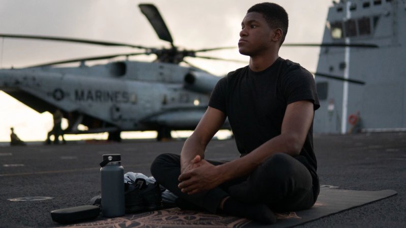 U.S. Marine Corps Cpl. Quince Bisard, a combat photographer with the 13th Marine Expeditionary Unit, participates in evening yoga, aboard the amphibious transport dock USS John P. Murtha (LPD 26), Nov. 26. The 13th MEU is embarked with the Makin Island Amphibious Ready Group, comprised of the amphibious assault ship USS Makin Island (LHD 8) and the amphibious transport docks USS Anchorage (LPD 23) and the John P. Murtha, conducting routine operations in U.S. 3rd Fleet. (U.S. Marine Corps photo by Cpl. Marcus E. Melara)