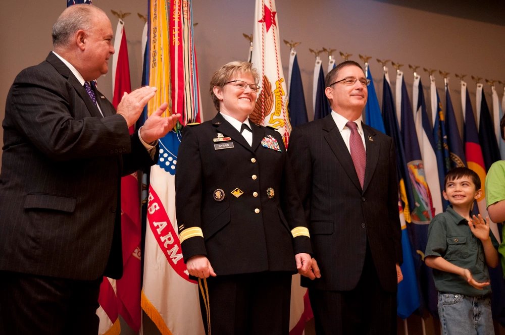 Under Secretary of the Army Joseph W. Westphal congratulates Maj. Gen. Dyson amid enthusiastic applause from a standing-room-only crowd, Aug. 27, 2012 at the Women in Military Service for America Memorial at Arlington National Cemetery, Va. Dyson is currently the director for Army Budget, Office of the Assistant Secretary of the Army (Financial Management & Comptroller). She is the first female Army Finance Corps officer to achieve the rank of major general.