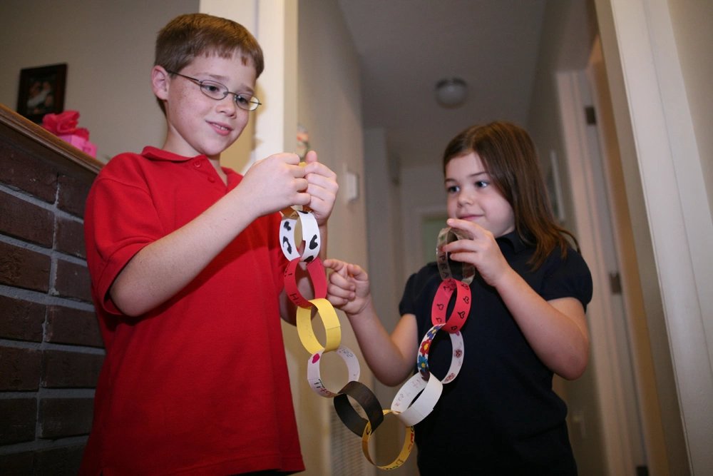 Jakob Knight, son of a Fightertown Marine, tears a piece of the paper chain off at their house, Oct. 13. Every week the children tear off a piece of paper and countdown when their father is supposed to return.