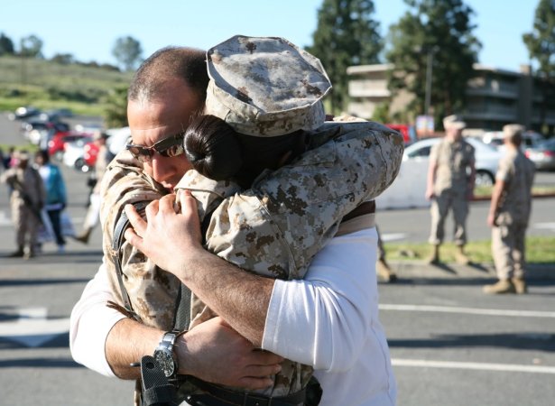 Gunnery Sgt. Nicole Mohabir, facility chief, Combat Logistics Regiment 17, 1st Marine Logistics Group embraces husband Mohaned Elokeill during the last few moments she has before she boards the bus to join the fight in Afghanistan, here, March 17.