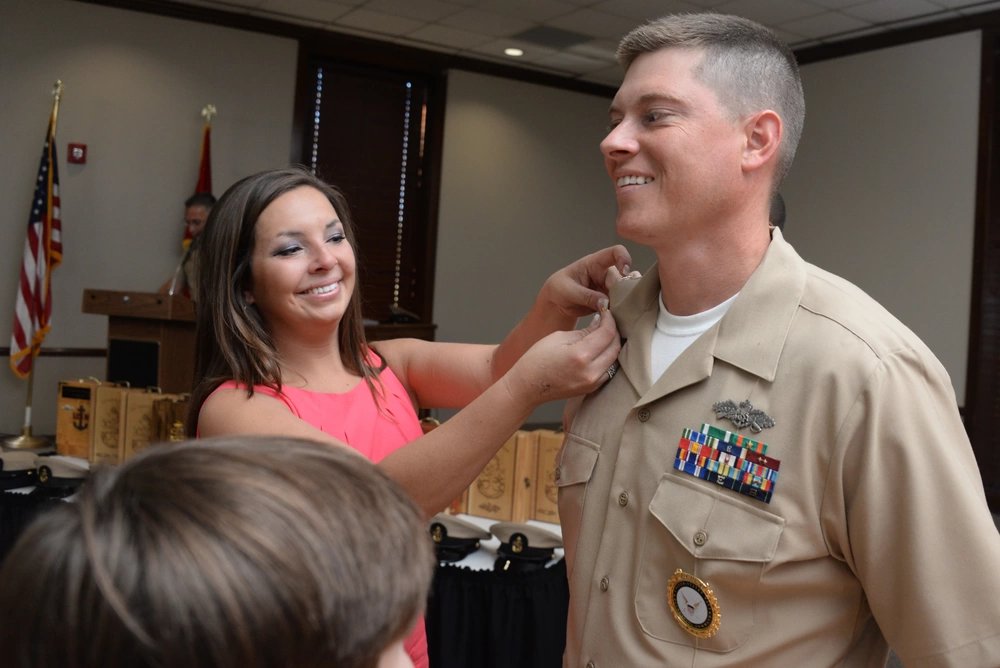 SMYRNA, Tenn. (Sept. 16, 2015) Chief Utilitiesman William Dean has his chief's anchors pinned by his wife during a chief petty officer pinning ceremony for 10 newly frocked chief petty officers from Navy Recruiting District Nashville, Navy Operations Support Center Chattanooga and Navy Operations Support Center Knoxville. (U.S. Navy photo by Mass Communication Specialist 1st Class Timothy Walter/Released)