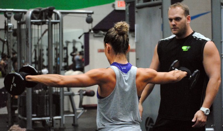 Brad Willis, personal training manager on Fort Bragg conducts a traininig session with Jacqueline Gomez, Sept. 17, 2014 at the Hercules Physical Fitness Center here. Gomez is currently training to compete as a bikini girl in the North Carolina National Physique Committee's 2014 Mid-Atlantic Classic on Oct. 25 in Charlotte, N.C. Willis has been training Gomez for four months now.