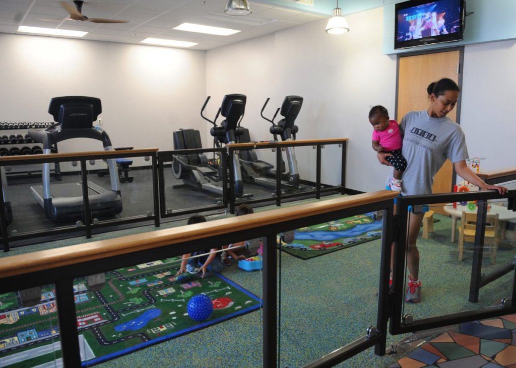 A mom and daughter enter the parent fitness room