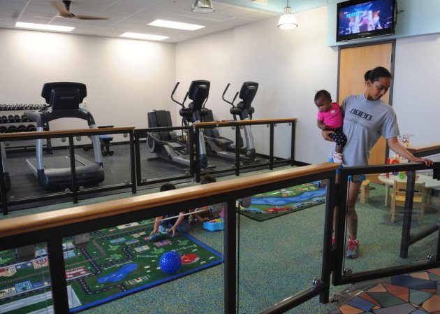 A mom and daughter enter the parent fitness room