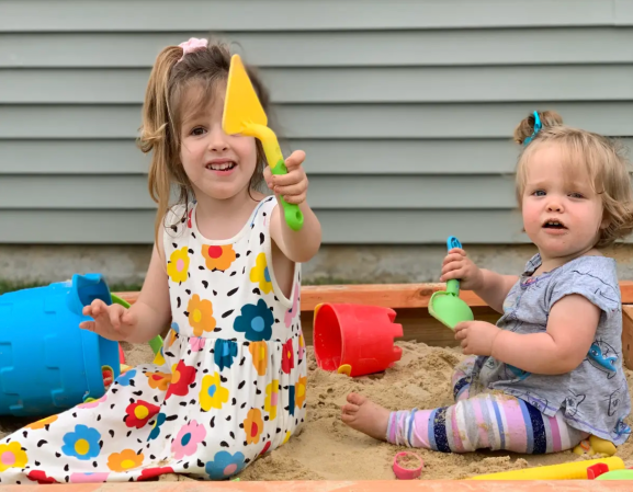 Girls play in sandbox