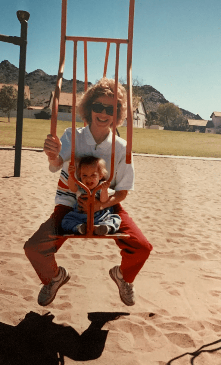 Mom and daughter swinging together