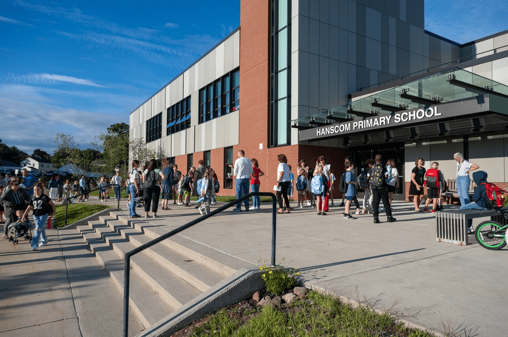 Students walk into the Hanscom School for the first day of classes at Hanscom Air Force Base, Mass. Aug. 29. The campus consists of a primary school for students in kindergarten through third grade and a middle school for students in fourth through eighth grade. (U.S. Air Force photo by Mark Herlihy)