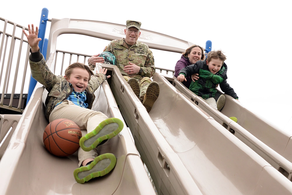 A family slides down a slide