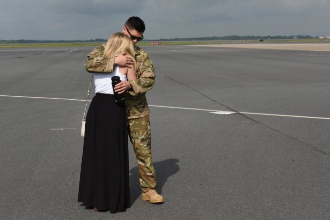 A deploying North Carolina Air National Guardsman hugs his wife and says goodbye before departure at the North Carolina Air National Guard Base, Charlotte Douglas International Airport, April 28, 2017. The day’s deployment kicks off the second wave of the North Carolina Air National Guard’s final C-130 deployment, a mission in support of Operation Freedom’s Sentinel.