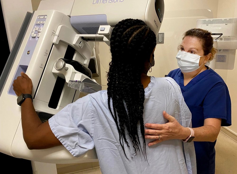 JACKSONVILLE, Fla. (Sept. 27, 2021) - Michelle Kincaid, a mammography technologist at Naval Hospital Jacksonville, assists a patient during a mammogram. Kincaid, a native of Allentown, Pennsylvania, says, “Being checked annually is the best way to catch cancer early.” TRICARE covers an annual screening mammogram for women age 40 and over. October is Breast Cancer Awareness Month. (U.S. Navy photo by Deidre Smith, Naval Hospital Jacksonville/Released