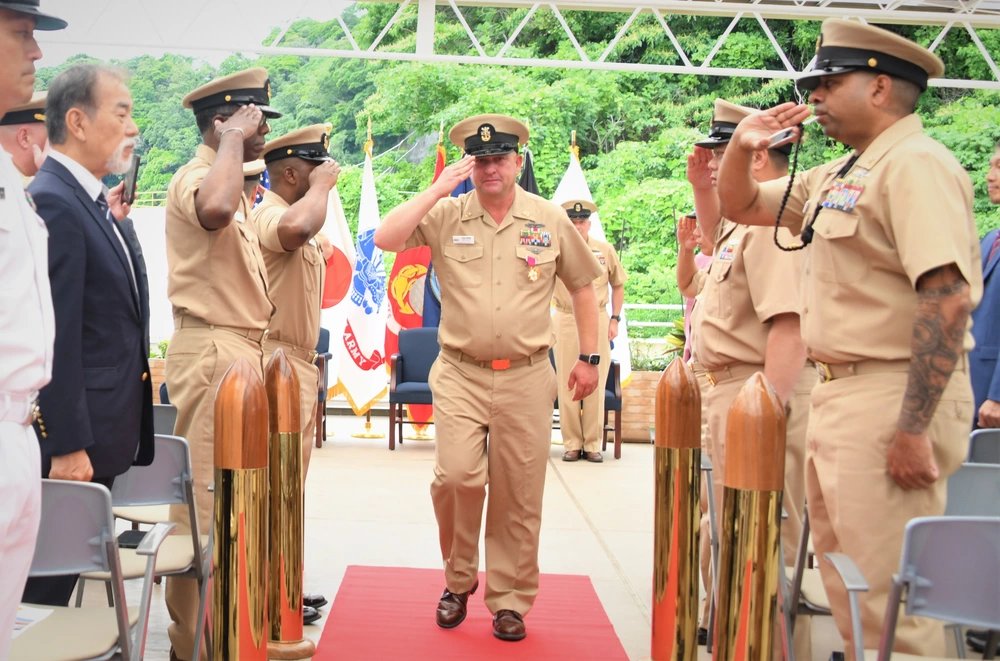 NAVSUP FLC Yokosuka (FLCY) Command Master Chief Todd Wende (middle) departs as the sideboys salulte him for the final time.