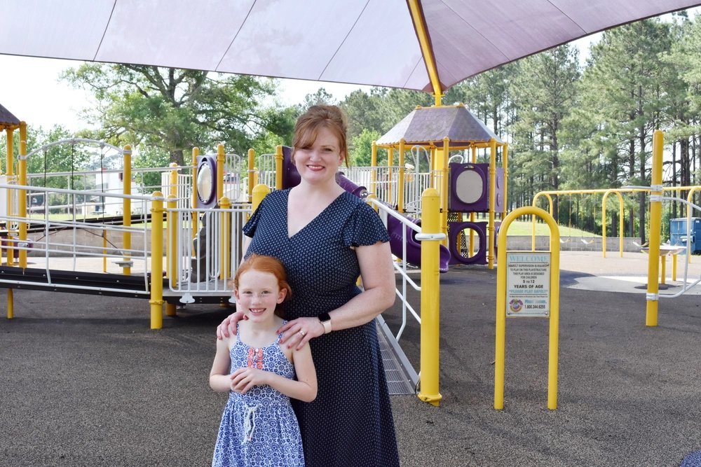 Kathleen Kent (right) stands with her daugther Esther (left) at the Catfish Cove playground on the Joint Readiness Training Center and Fort Polk. Kent linked up with a school liaison officer after a friend recommended School Support Services to her, prior to transitioning to JRTC and Fort Polk.