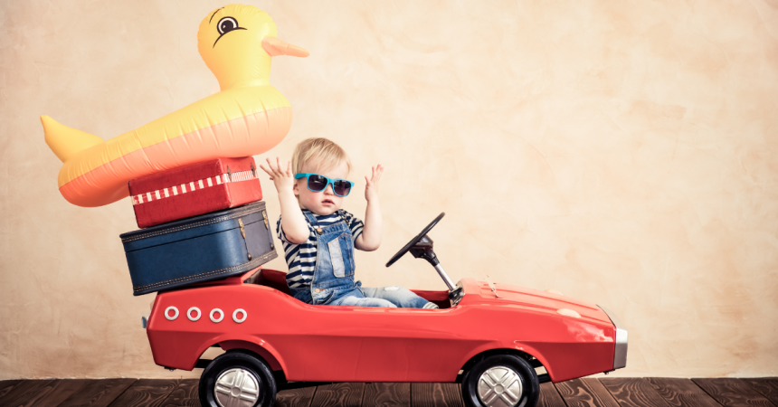 Toddler rides a car with a rubber ducky float