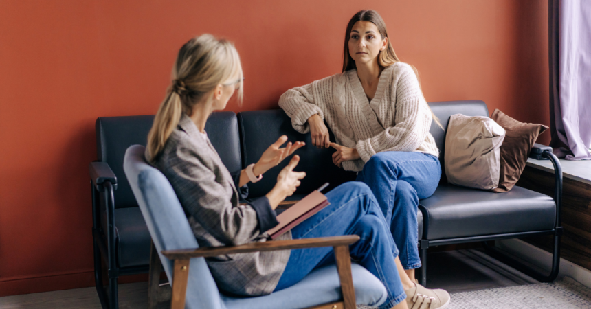 A woman speaks to a therapist. Photo via Canva.