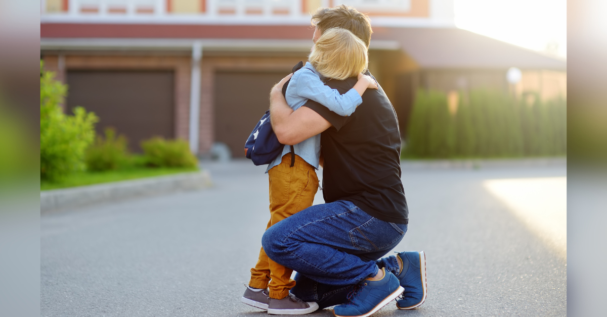 a dad hugs his son