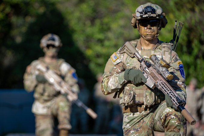 FORT BENNING, Ga. – Soldiers of the 4th Ranger Training Battalion, Airborne and Ranger Training Brigade, demonstrate the U.S. Army’s newest weapon during a Rangers in Action Ceremony September 16, 2022, at Victory Pond, Fort Benning, Georgia. The XM5 Rifle will replace the M4/M4A1 carbine within the close combat force. The new ammunition includes multiple types of tactical and training rounds that increase accuracy and are more lethal against emerging threats than both the 5.56mm and 7.62mm ammunition. (U.S. Army photo by Patrick A. Albright, Maneuver Center of Excellence and Fort Benning Public Affairs)