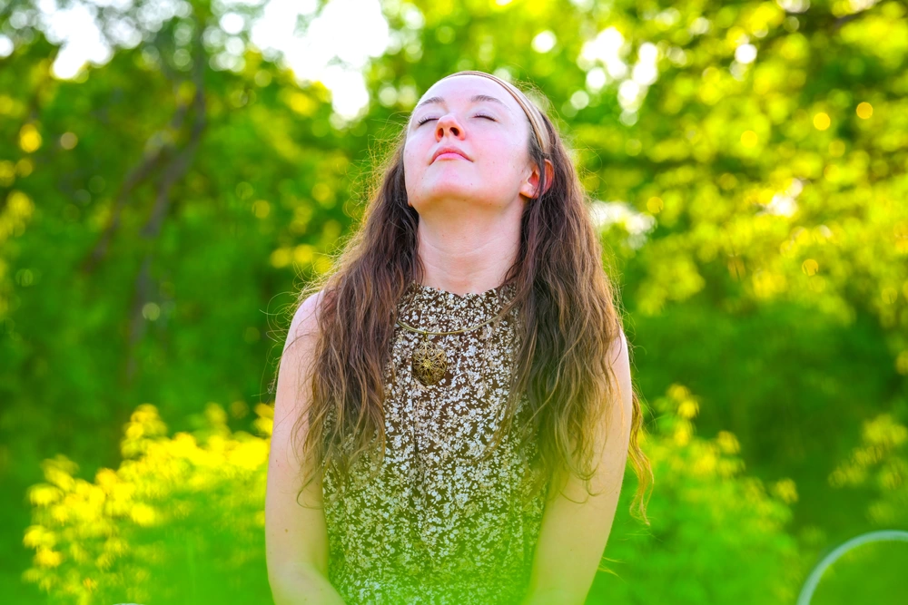 woman meditates in a field