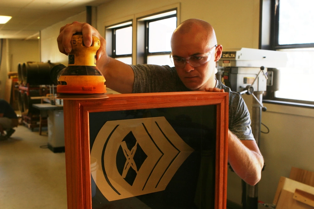 Cpl. Mariusz M. Martynowicz, 22, from Chicago, a vehicle mechanic with Motor Transport Maintenance Company, 1st Maintenance Battalion, Combat Logistics Regiment 15, 1st Marine Logistics Group, sands a shadow box that will be given as a gift to his retiring gunnery sergeant at Camp Pendleton's Marine Corps Community Services Arts and Hobby Shop, July 12. The 6,000 sq. ft. arts and crafts facility offers a variety of activities ranging from woodworking, building ceramics and painting pottery, digital photography lessons, to private birthday rooms at a reasonable price