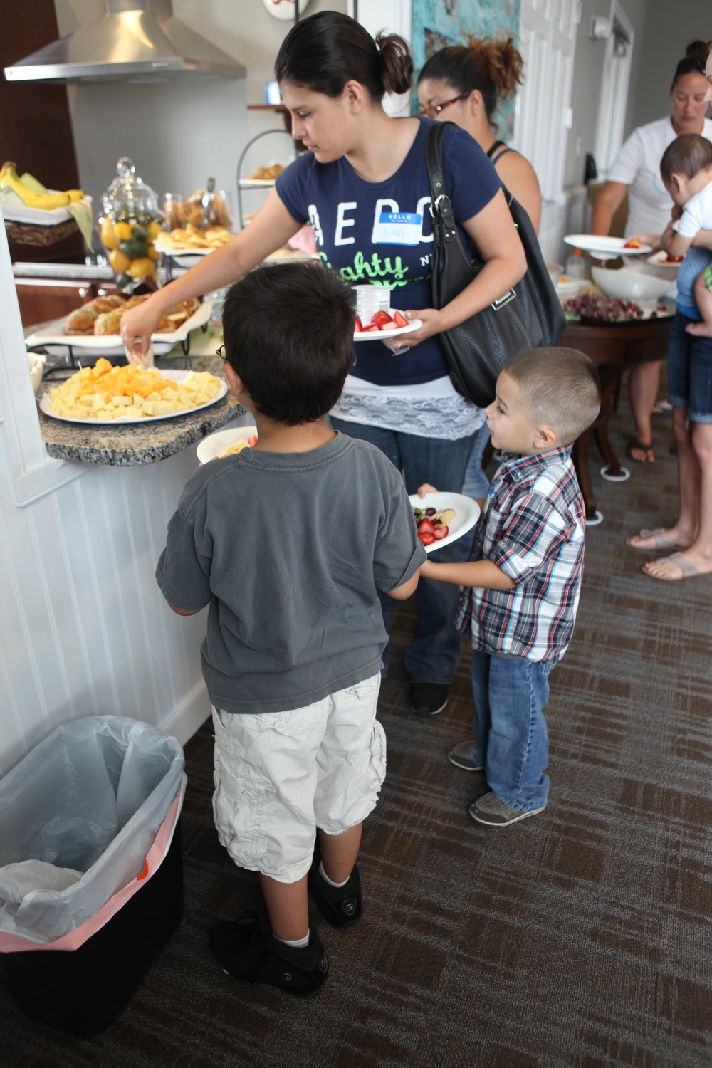 Jesey McManus, a volunteer caseworker with the Navy-Marine Corps Relief Society, speaks with guests of the society's 70th birthday celebration at the NMCRS office aboard Marine Corps Base Camp Lejeune, May 9. The event offered free lunch and dessert to base patrons as a way to increase awareness about the availability of assistance from NMCRS for Marines, sailors and families.