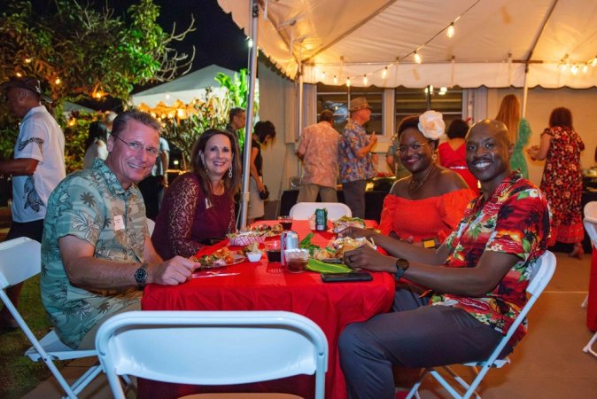 From left; U.S. Air Force Brig. Gen. Thomas Palenske, commander, 36th Wing, Anderson Air Force Base; Jeryn Palenske; Markoya Taylor; Chief Master Sgt. Nicholas Taylor, 36th Wing command chief, AAFB; pose for a photo at their dinner table at Nimitz House Dec. 16 during a holiday party hosted by Rear Adm. Gregory Huffman, commander, Joint Region Marianas, and his wife Judy. The JRM commander hosts this event annually for local leaders, staff and their families at the historic Nimitz House, which has served as the private residence for the regional commanders since World War II. (U.S. Navy photo by Mass Communication Specialist 1st Class Samantha Jetzer)