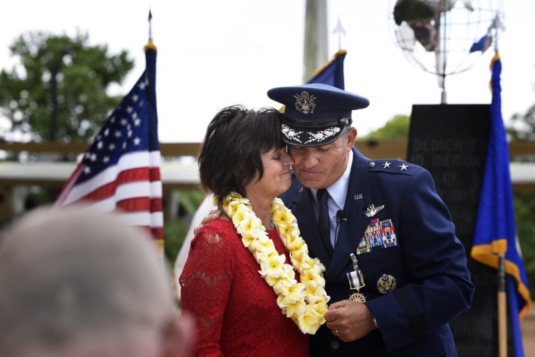 U.S. Air Force Maj. Gen. Todd Kelly (right), Air National Guard Assistant to the Commander, Air Mobility Command, and his spouse, Renee (left), show affection during his retirement ceremony held at the North Carolina Air National Guard Base, Charlotte Douglas International Airport, May 6, 2017. In lieu of a flower bouquet, Kelly gave his spouse a Hawaiian lei in appreciation.