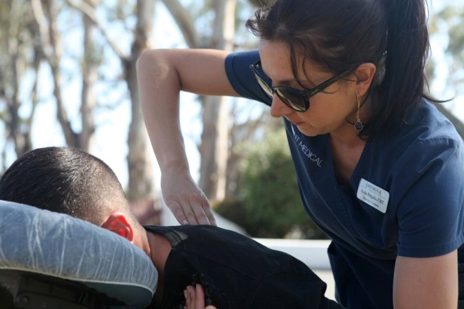 Rocio Delgado with Joint Medical, provides free massages to Marines and their families during the 1st Intelligence family day at Camp Pendleton, Calif., May 17.