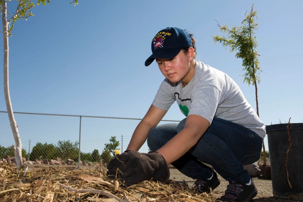 U.S. Air Force Senior Airman Katherine Pendergast, 99th Dental Squadron dental assistant, spreads mulch around a tree during a volunteer tree planting at Veterans Memorial Park, Aug. 2, 2012, in Boulder City, Nev. The 25-acre Veterans Memorial Park features four lighted multi-use ballfields, two beach volleyball courts, a fishing pond, a model boat pond, soccer fields, a skateboard and bike park, and acres of open green space. IMAGE INFO Date Taken: 08.02.2012 Date Posted: 08.13.2012 13:14 Photo ID: 644519 VIRIN: 120802-F-OS776-021 Resolution: 4256x2832 Size: 1.27 MB Location: NELLIS AIR FORCE BASE, NEVADA, US Web Views: 28 Downloads: 7 PUBLIC DOMAIN This work, Volunteer Tree Planting [Image 2 of 2], by SSgt Christopher Tam, identified by DVIDS, must comply with the restrictions shown on https://www.dvidshub.net/about/copyright.