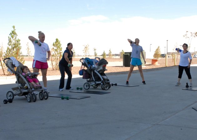 Military spouses of Fort Bliss conduct dumbbell lifts during a Stroller off Stress class at the Soto Physical Fitness Facility on East Fort Bliss, Sept. 17. The Morale, Welfare and Recreation sponsored class is designed to help participants stay in shape and build their own personal fitness regiment. (U.S. Army photo by: Sgt. Terence Ewings, 24th Press Camp Headquarters.)