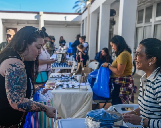 Naval Station (NAVSTA) Rota community members gather at the chapel's courtyard to shop the home-based business fair prior to the Entrepreneurship Essentials Road Show, Sept. 28, 2023.