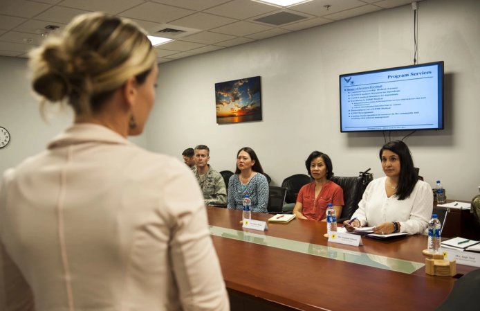 Sharene Brown, spouse of U.S. Air Force Gen. CQ Brown, Jr., Pacific Air Forces (PACAF) commander, and Stephanie Johnson, spouse of Chief Master Sgt. Anthony Johnson, PACAF command chief, listen to a briefing by Whitney White, 18th Medical Support Squadron exceptional family member program special needs coordinator, during the PACAF commander's visit at Kadena Air Base, Japan, Oct. 22, 2018. PACAF spouses visited Kadena Air Base to learn about the base's mission, operations and readiness programs. (U.S. Air Force photo by Naoto Anazawa)